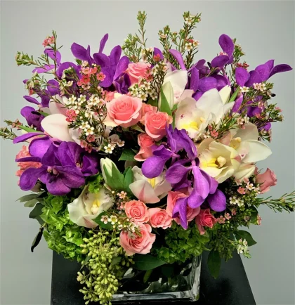The Mix Lavender Orchids, Roses, Wax Flower, Etc